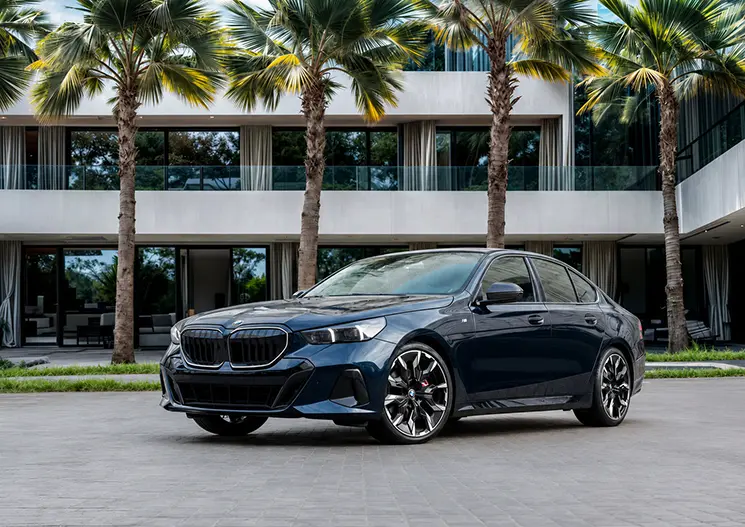 Illustrative dark current-generation BMW 5 Series executive sedan for a chauffeur request in Dubai