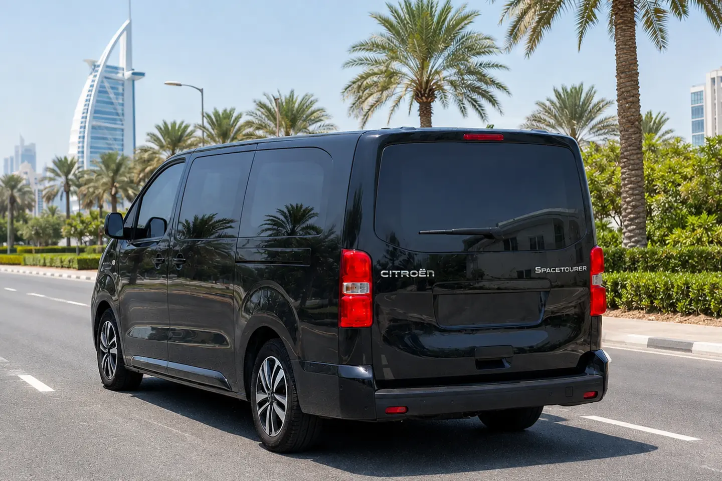 Rear and side view of a black Citroën SpaceTourer passenger van with closed doors and no plates in Dubai